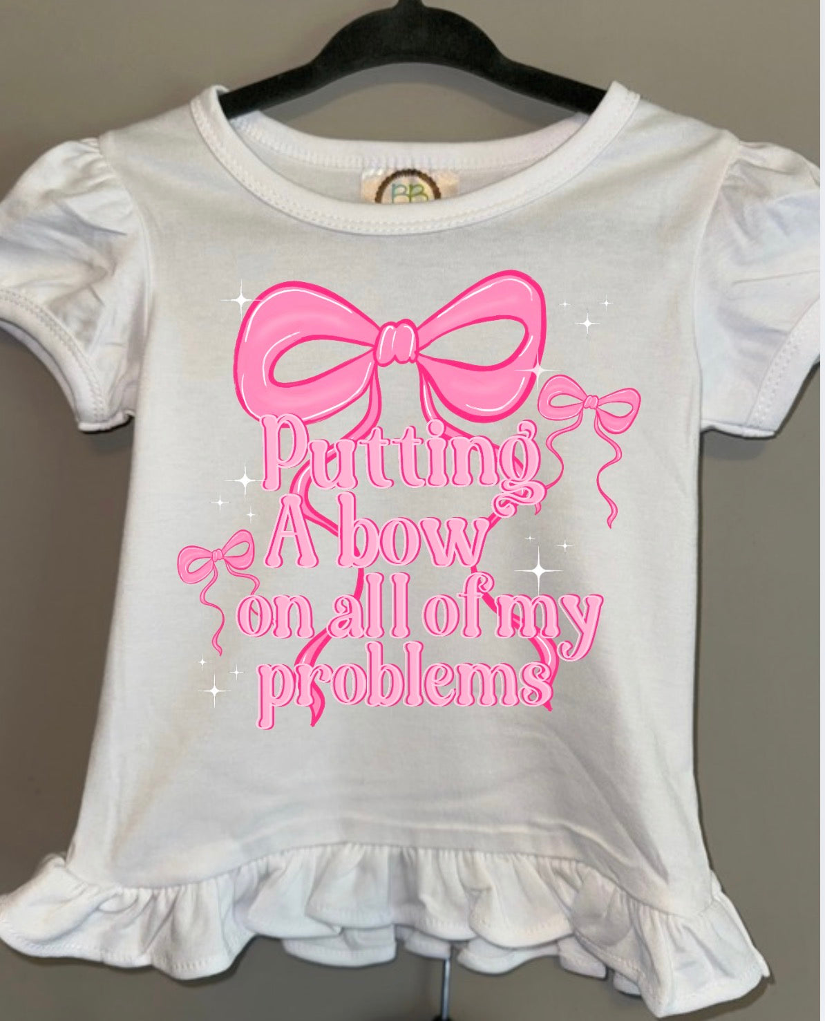 Putting a Bow on All my problems Girls Ruffle Tee